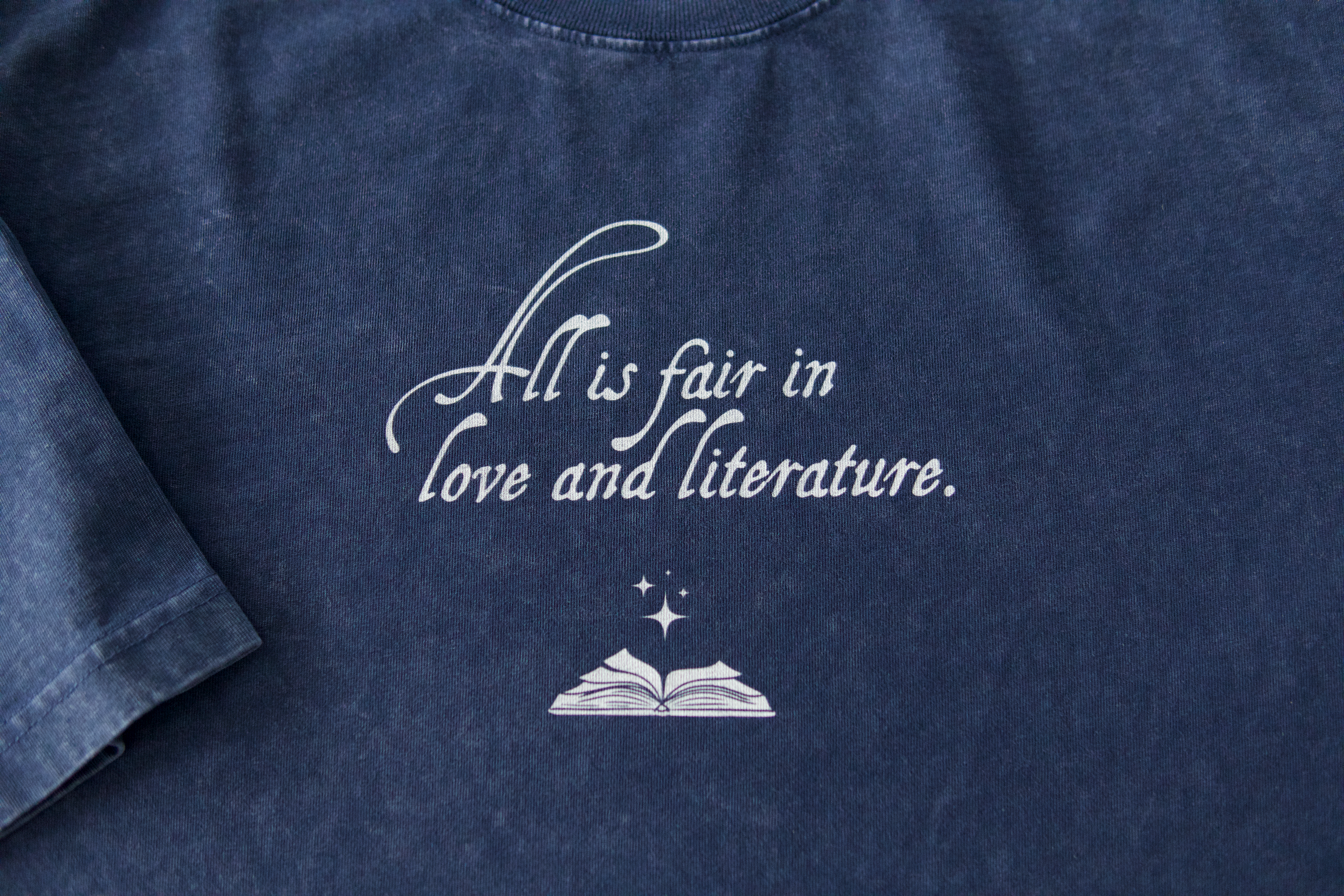Close-up of mineral wash cotton fabric and printed text on bookish graphic t-shirt
