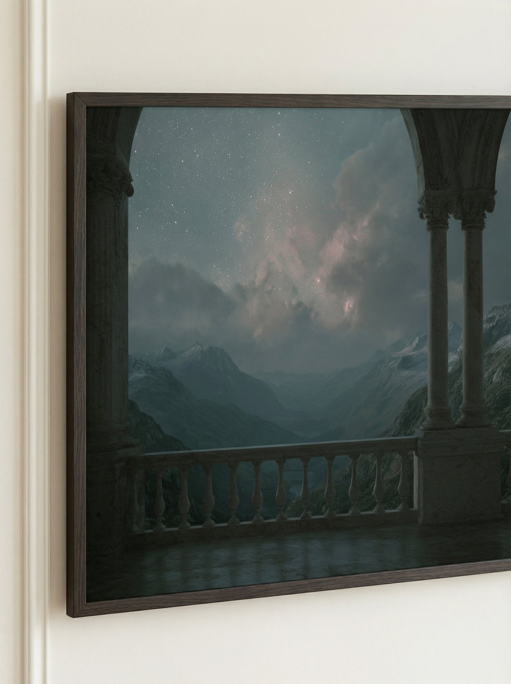 Close-up of a framed artwork showing a marble balcony overlooking misty mountains beneath a glowing starry sky.