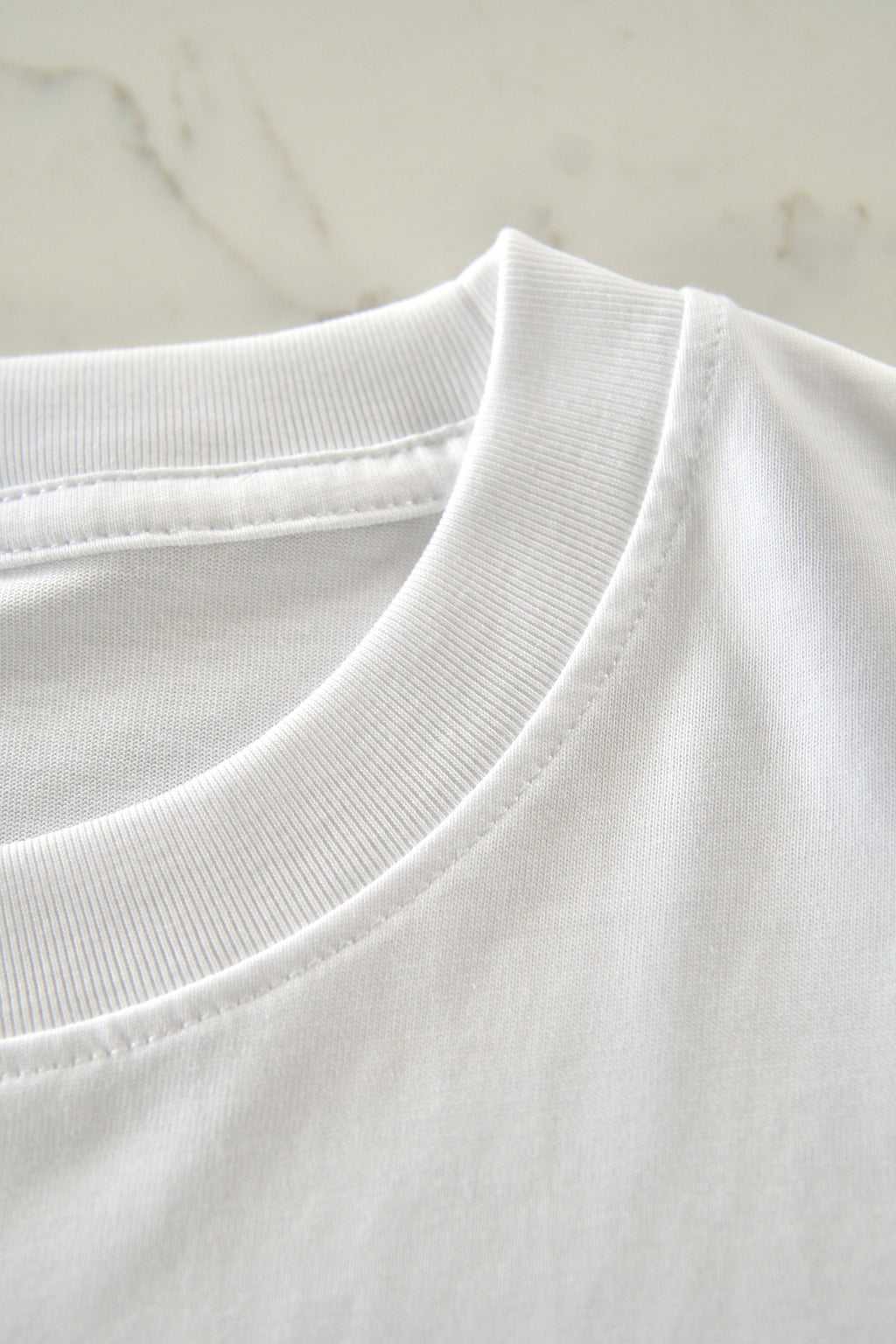 Close-up of a white shirt collar on a light gray background